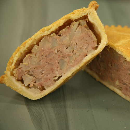 Close-up of a hand-raised meat and potato pie